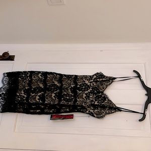 Tags on black lace midi dress